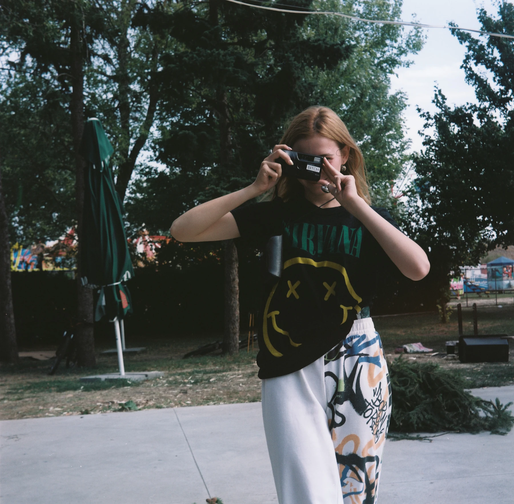 Žena fotografuje pod stromy